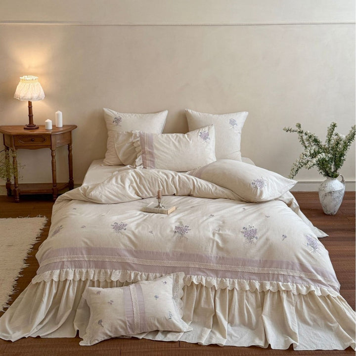 Vintage-inspired bedding set with ruffled bed skirt and delicate floral embroidery