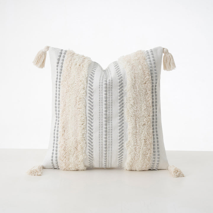 Square decorative cushion with boucle stripes, woven texture, and corner tassels