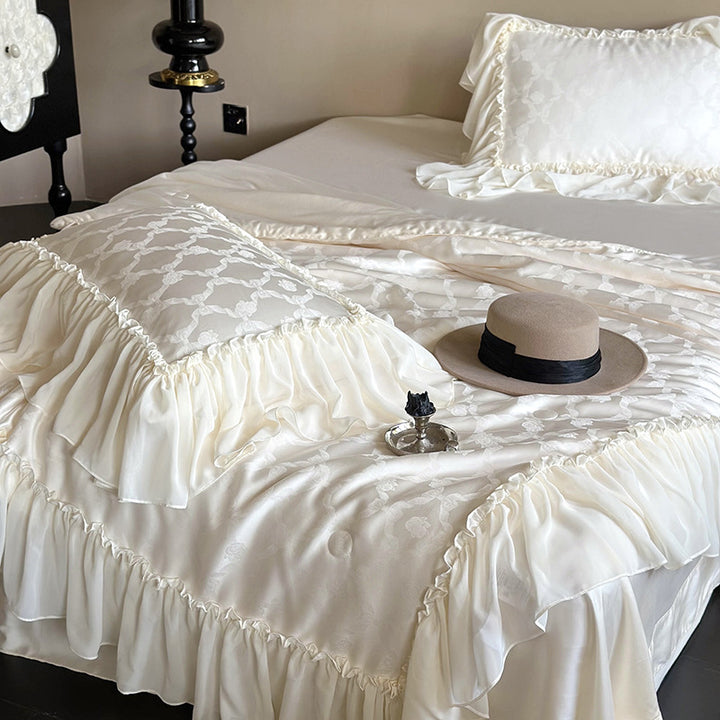 Elegant satin bed linen set with generous ruffle trim and tone-on-tone jacquard pattern