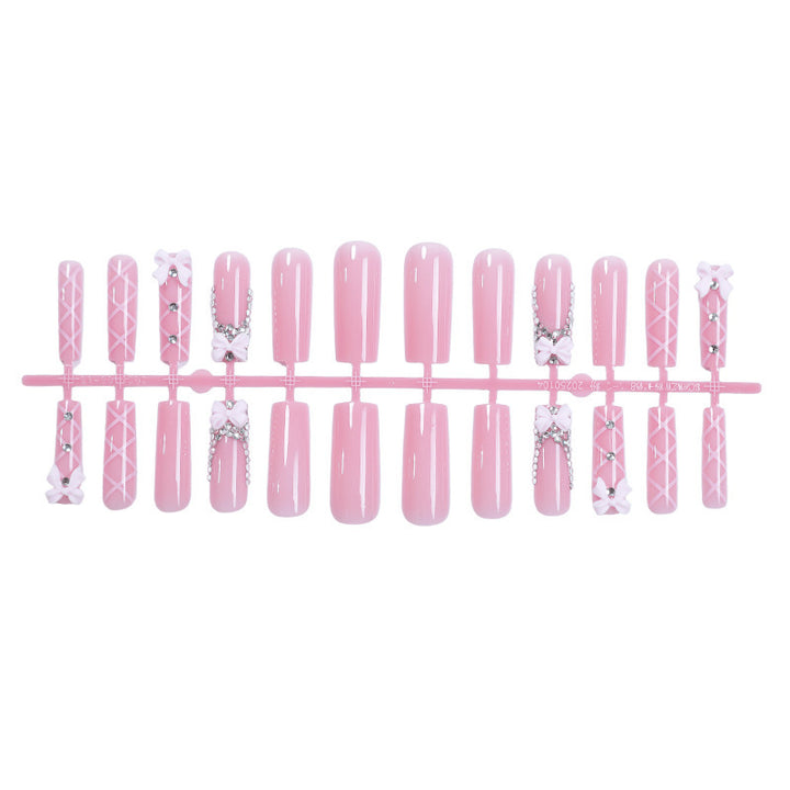 Acrylic nail set with elegant bow and glitter accents Kalsten