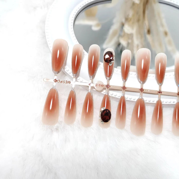 Glamorous artificial nails in elegant ombre style with rhinestone embellishments Kalsten