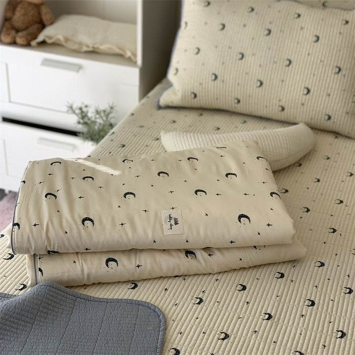 Padded children's bed pad and play mat made of quilted cotton with duck print