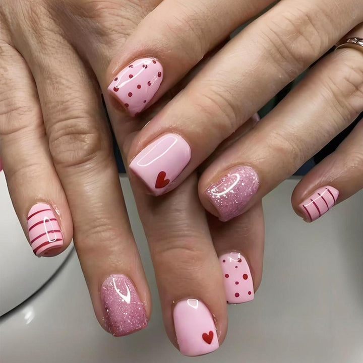 Acrylic nail set with playful hearts and glitter accents Kalsten