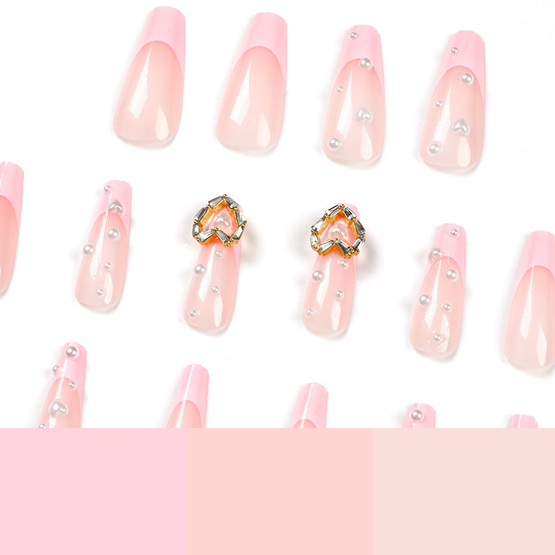 Artistic nail art with heart and pearl accents Kalsten