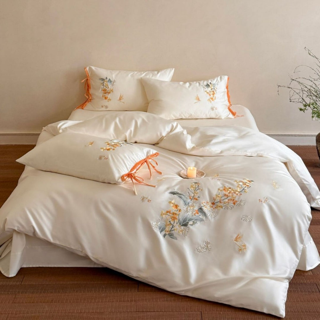 Luxurious satin bedding set with floral embroidery and bow appliqué