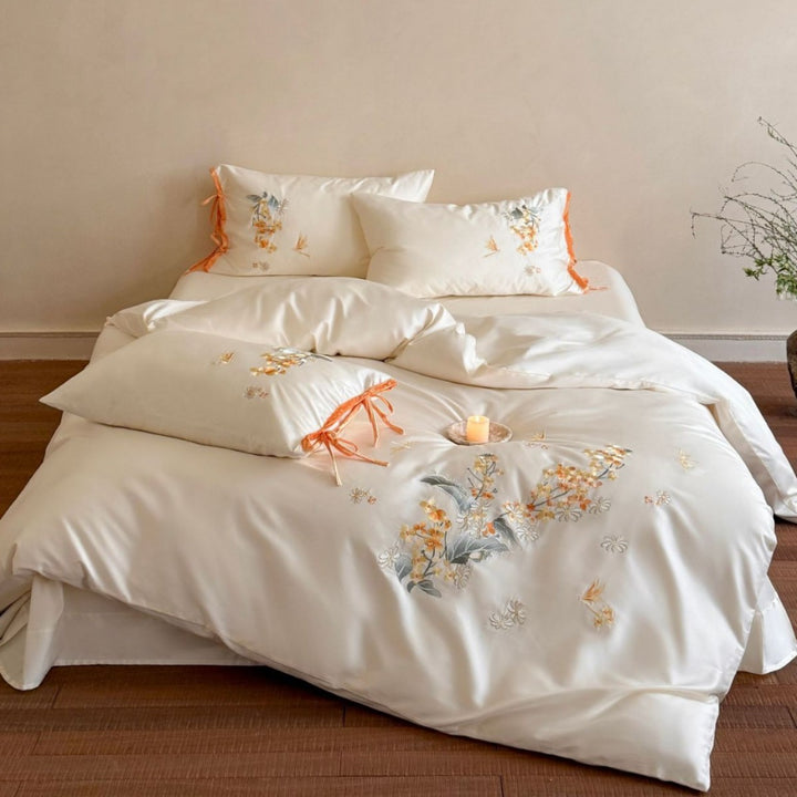 Luxurious satin bedding set with floral embroidery and bow appliqué