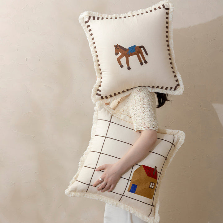 Decorative cushion cover made of cotton blend with fringes, check pattern and embroidered house Kalsten