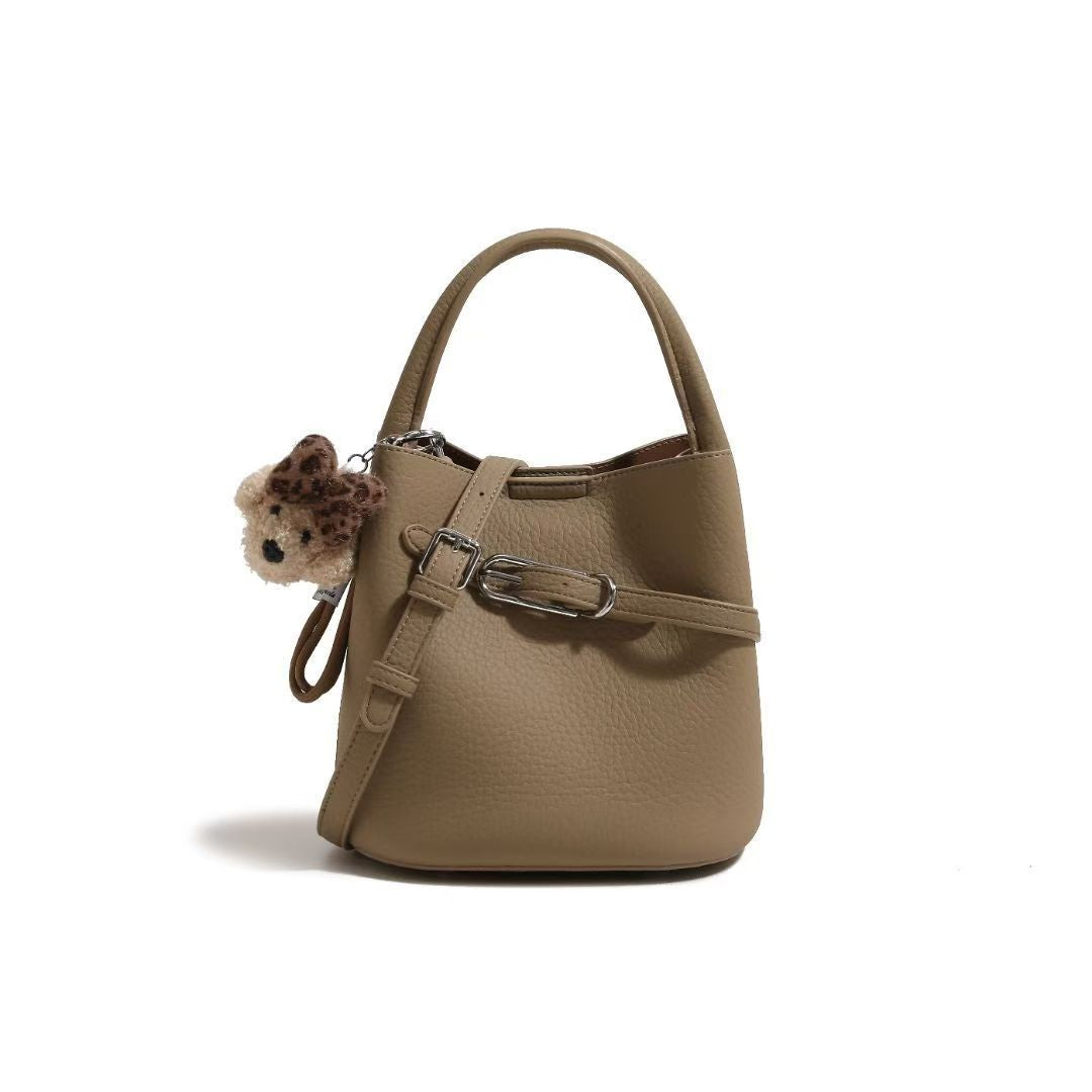 Chic Pebbled Leather Handbag with Cute Charm