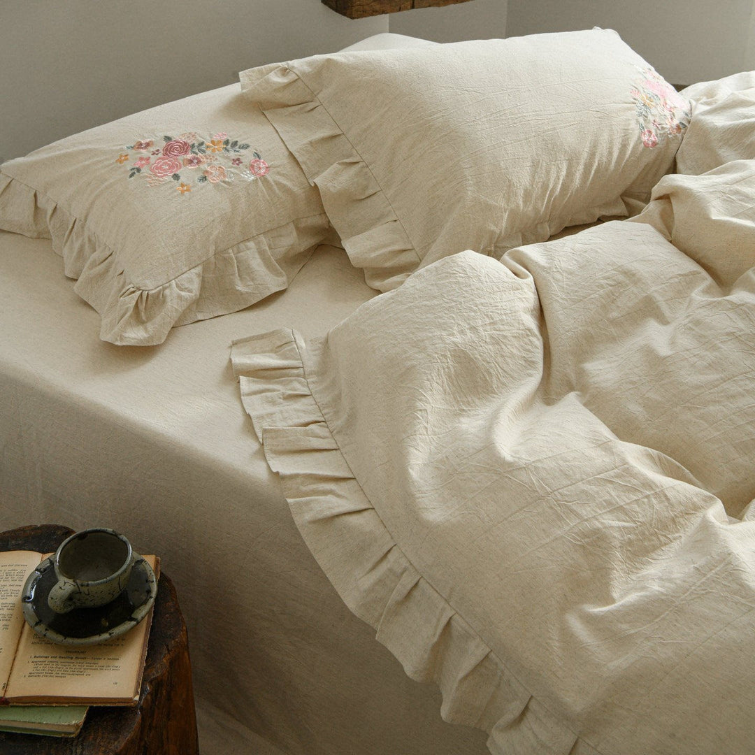 Embroidered linen-look bedding set with ruffle and floral embroidery detail