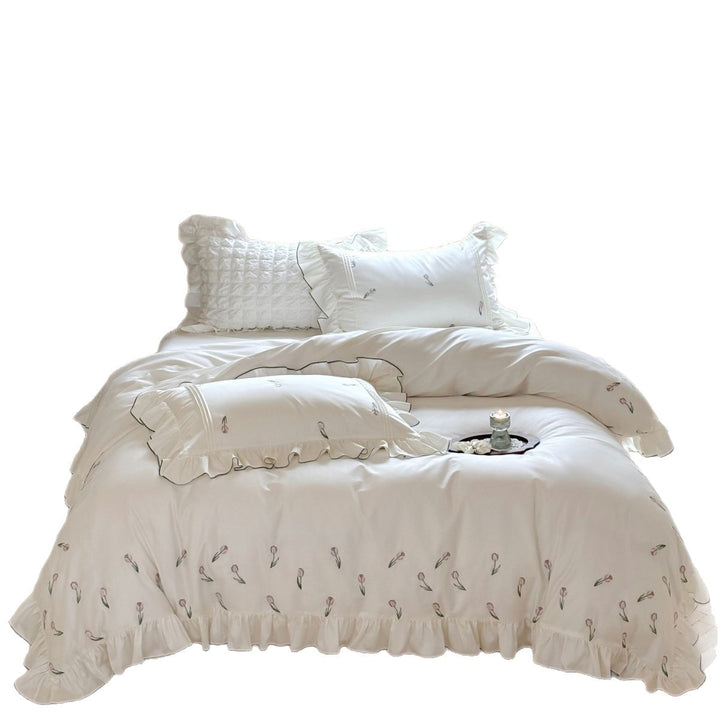 Romantic cotton percale bedding set with ruffled hem and embroidered tulip motif