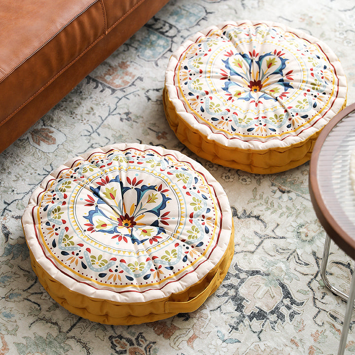 Round floor cushion with medal print, carrying handle and quilted padding