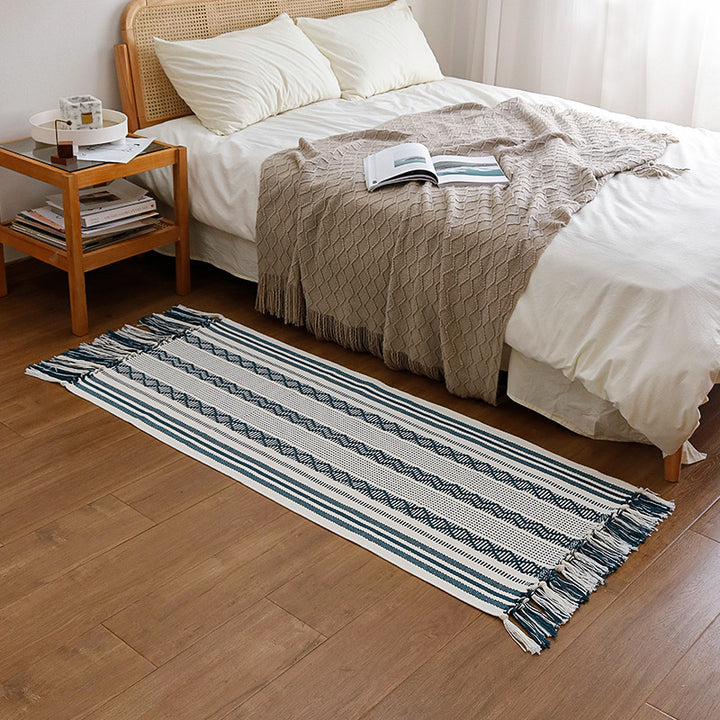 Handwoven cotton runner with low pile, fringes, and geometric stripe pattern