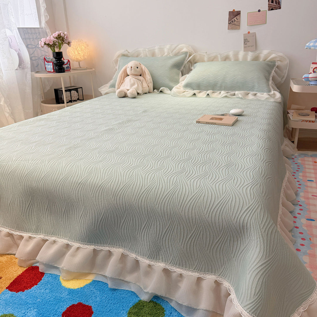 Quilted bedspread with ruffle and delicate floral quilting