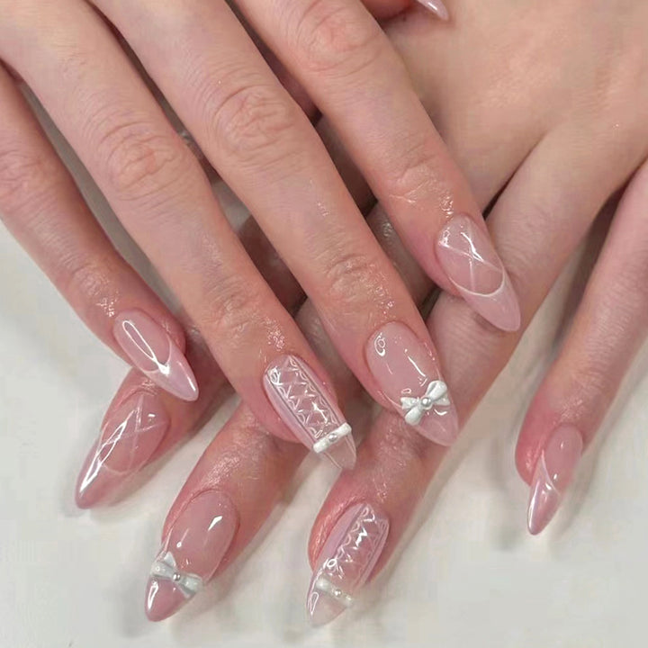 Artistic stiletto nails with elegant pearl and bow accents Kalsten