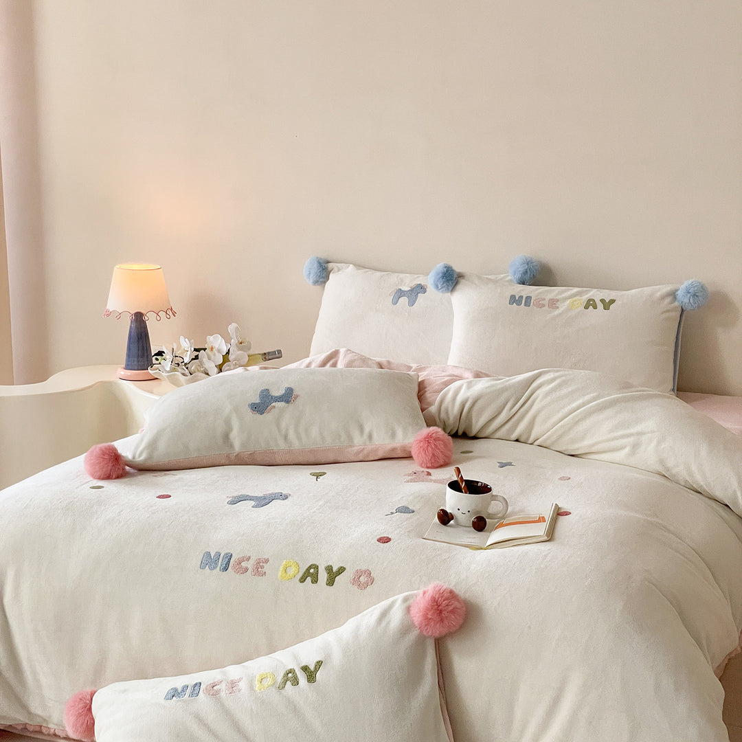 Cozy cotton bedding set with pom-pom appliques and embroidered lettering