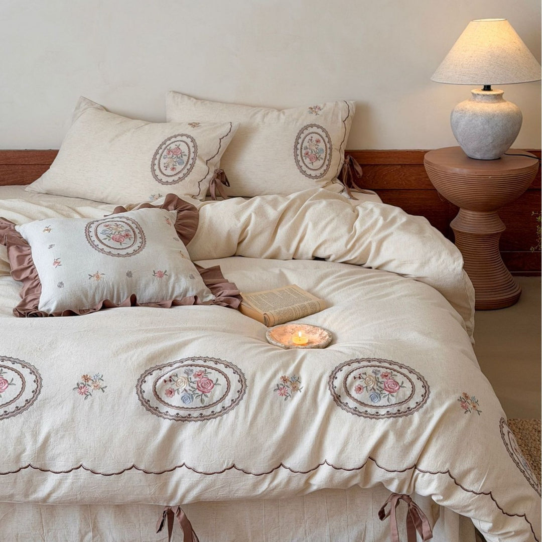 Romantic cotton-linen bedding set with embroidered flower medallions and ruffles