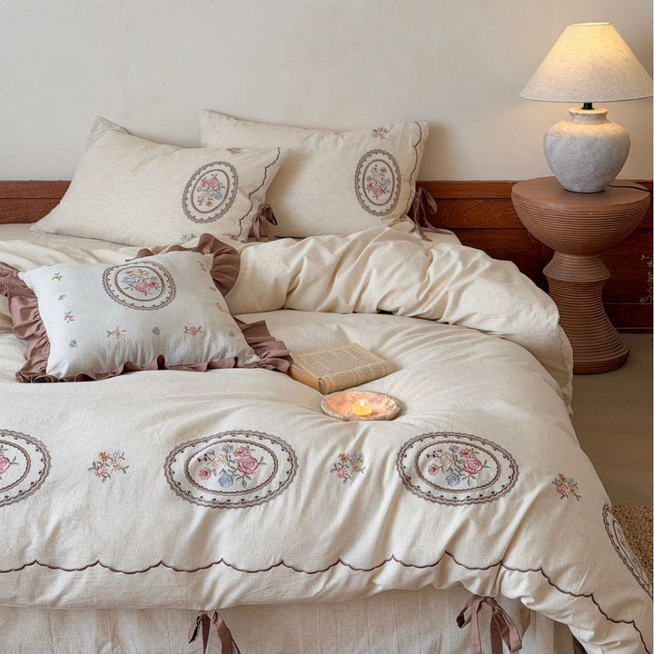 Romantic cotton-linen bedding set with embroidered flower medallions and ruffles