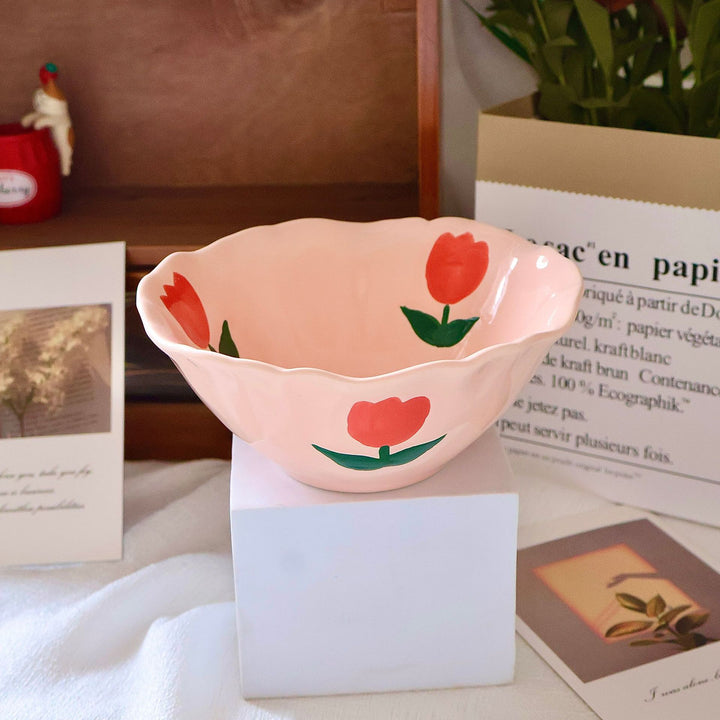 Decorative hand-painted ceramic bowl with wavy edge and tulip design
