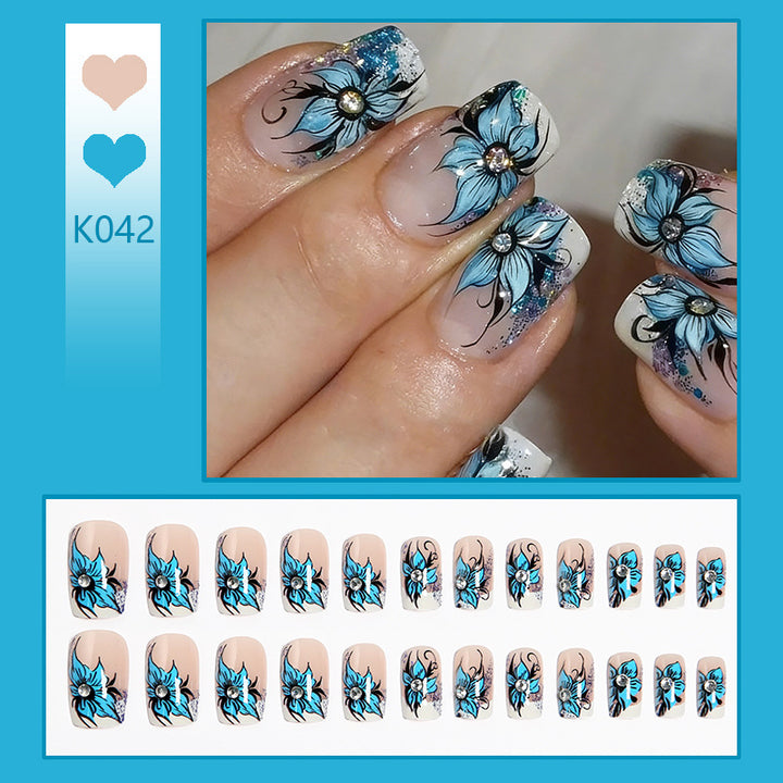 Artificial nail set with intricate floral designs and glitter elements Kalsten