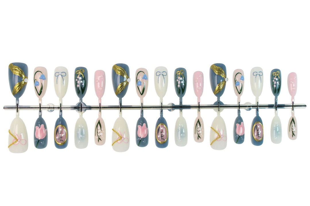 Acrylic nail set with floral design and elegant gold embellishments Kalsten