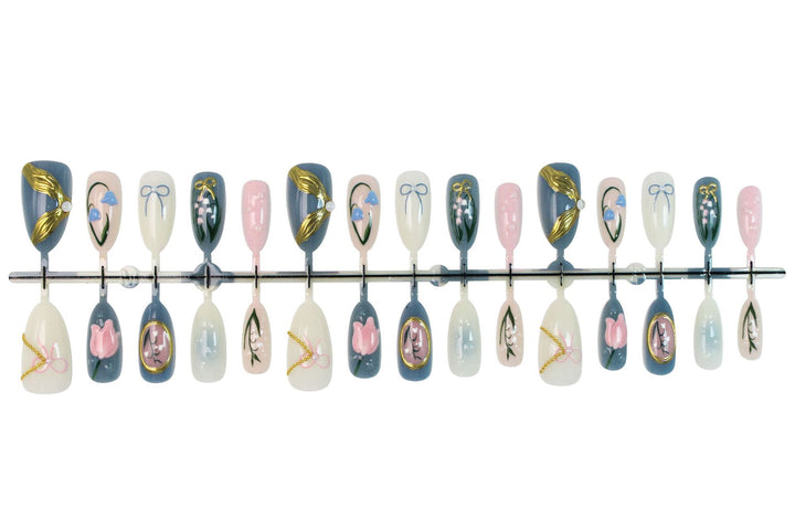 Acrylic nail set with floral design and elegant gold embellishments Kalsten