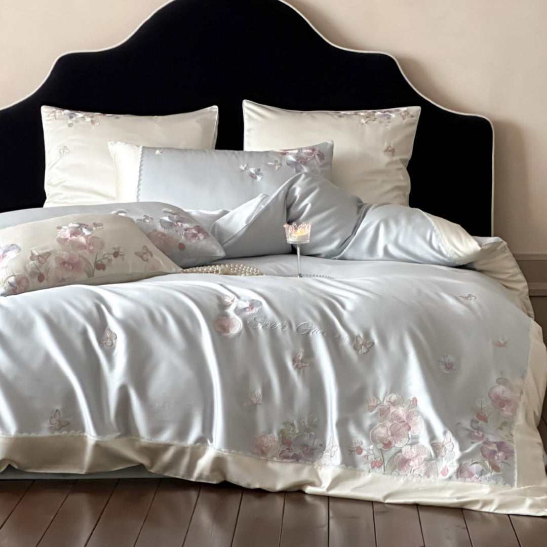 Luxurious satin bedding set with floral embroidery and butterfly appliqué