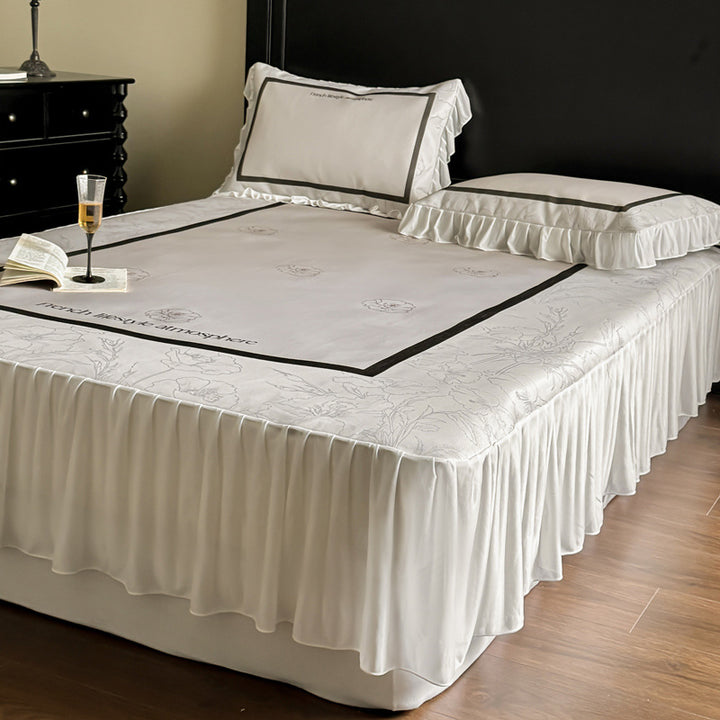 Bedding set with ruffled bed skirt, floral printed center piece and frill pillow