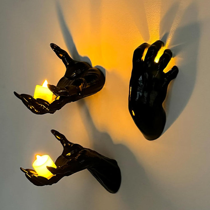 Wall candle holder in realistically shaped hand made of resin
