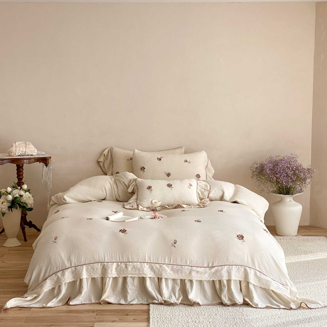 Bedding set made of cotton percale with frill hem, floral embroidery, and decorative ribbons