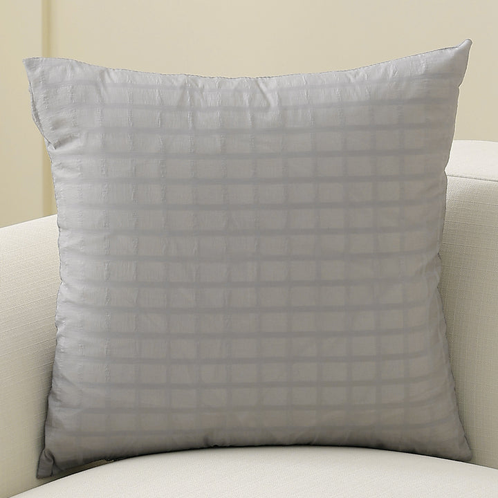 Square decorative cushion with delicate mother-of-pearl look and fine micro tuft structure