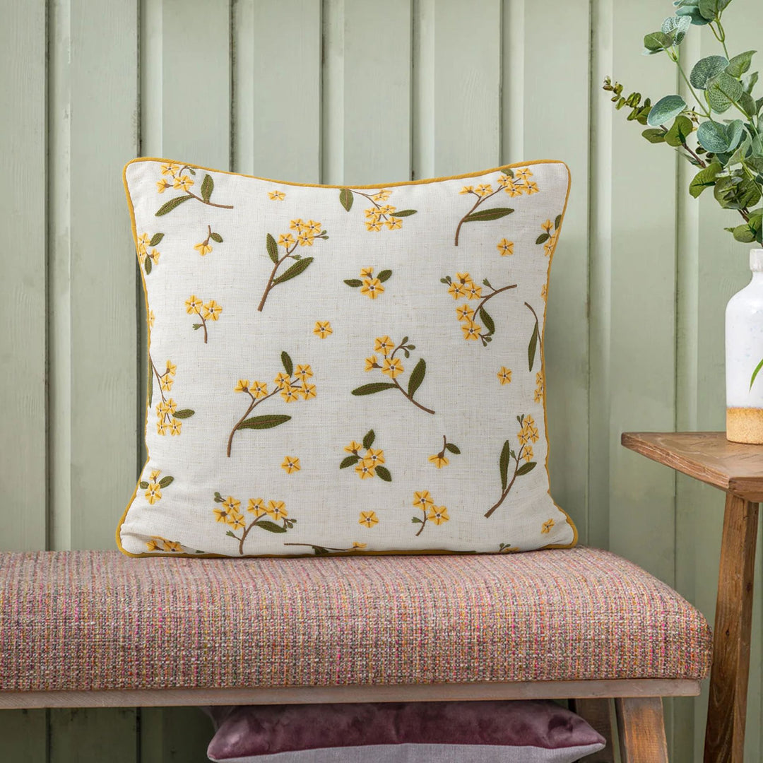 Embroidered linen decorative pillow with floral embroidery and piping