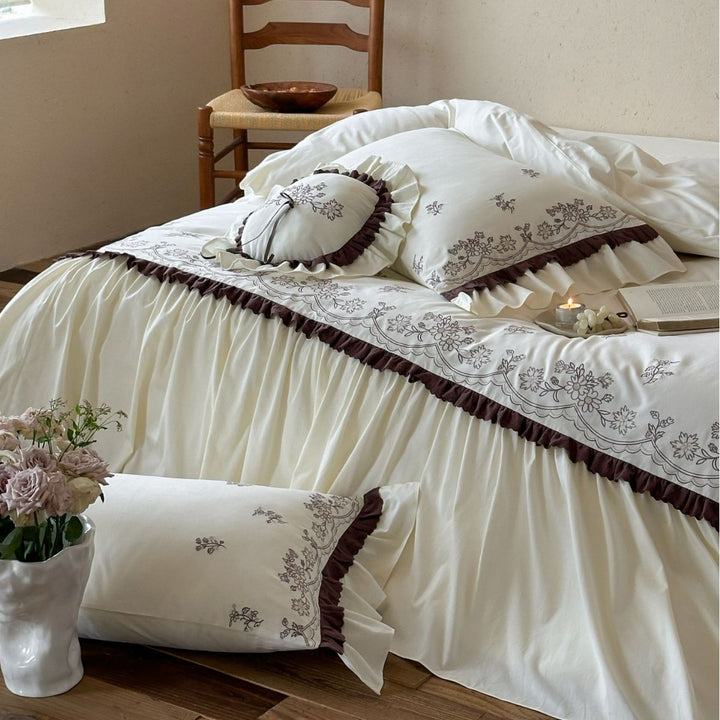 High-quality embroidered bedding set with ruffled bed skirt and decorative cushion