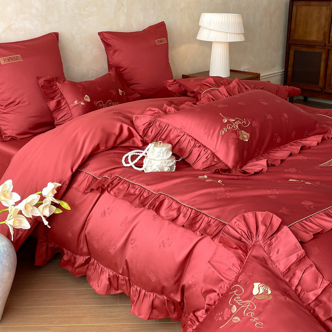 Romantic satin bedding set with ruffles, fine floral embroidery, and reversible pillowcase