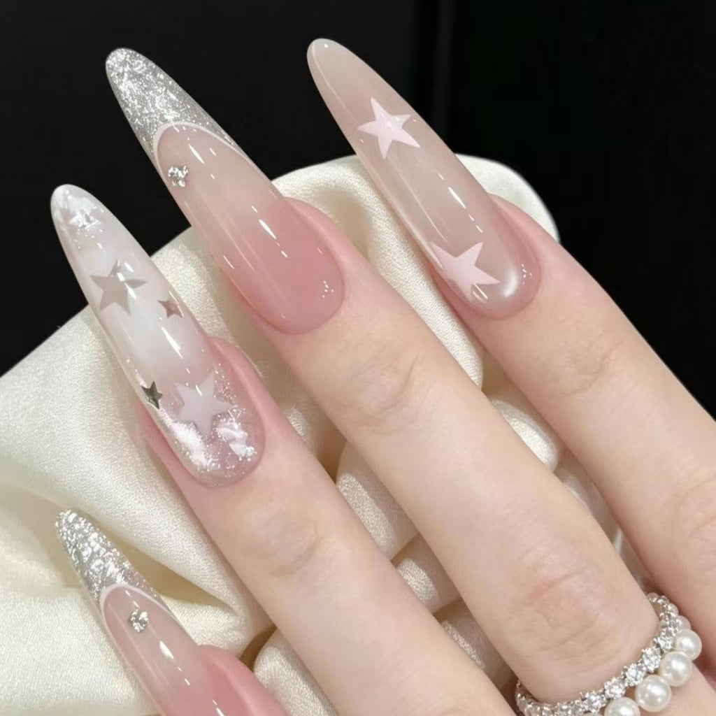 Stiletto Nail Enhancements with Glitter and Star Accents