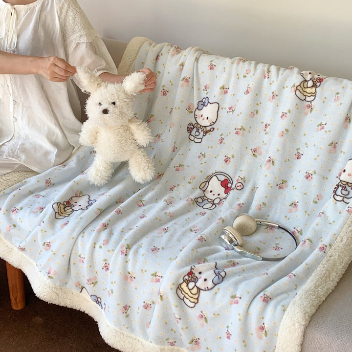 Reversible fleece blanket with cartoon cat design and teddy lining