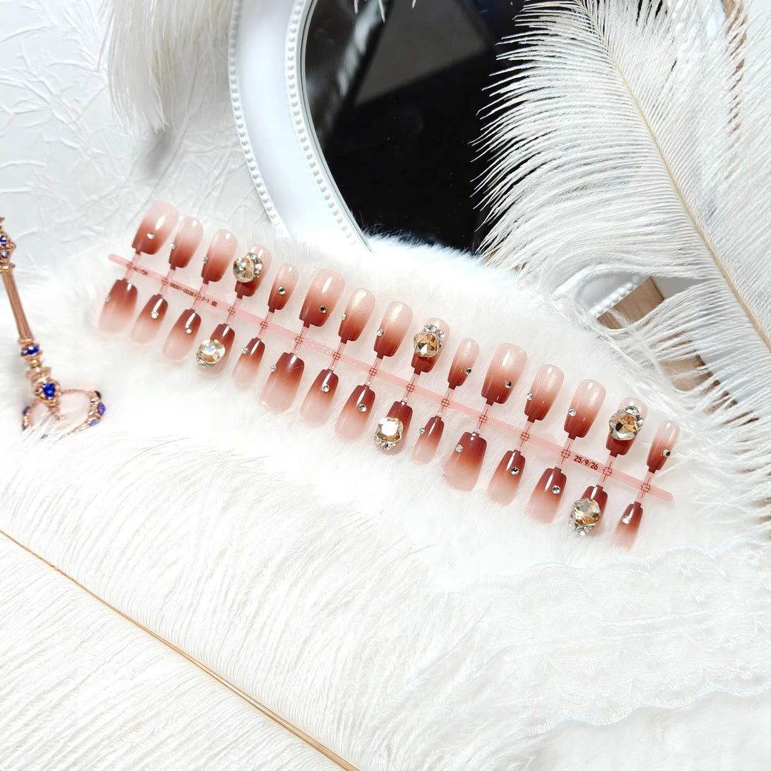 Artificials nails in elegant ombre style with rhinestone embellished applications Kalsten