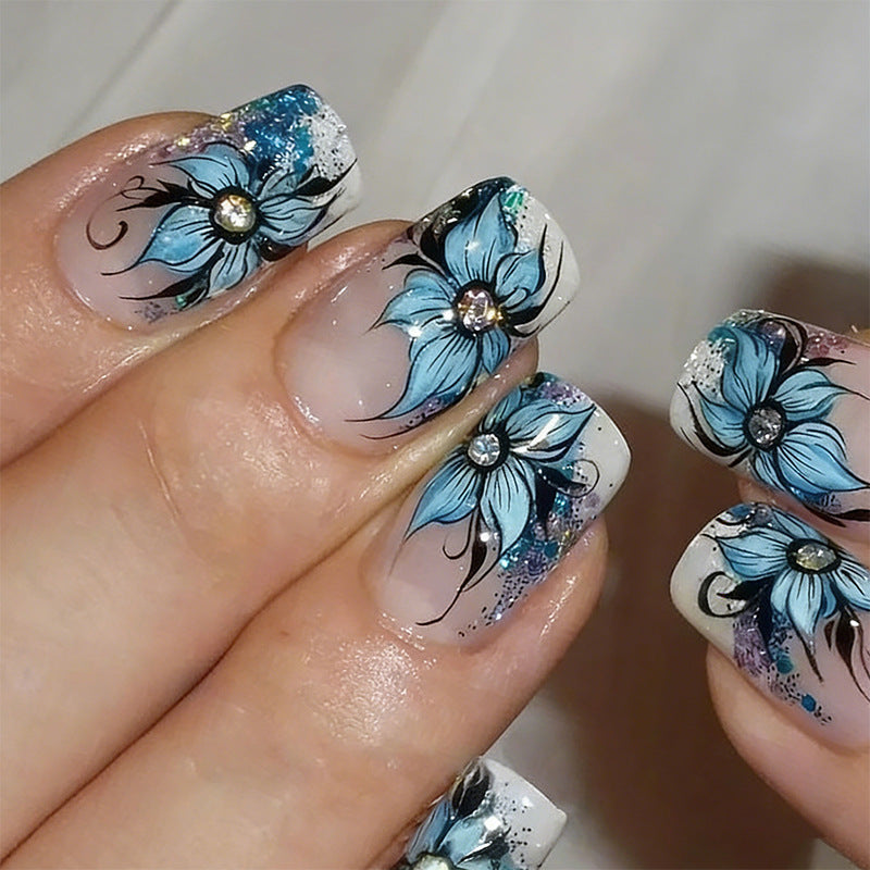 Artificial nail set with intricate floral designs and glitter elements Kalsten