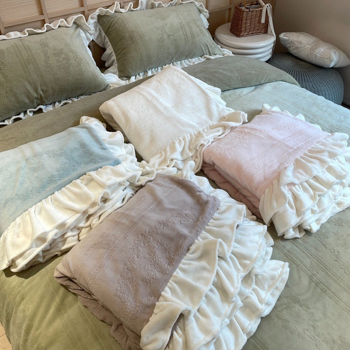 Quilted bedding set with ruffle and medallion relief