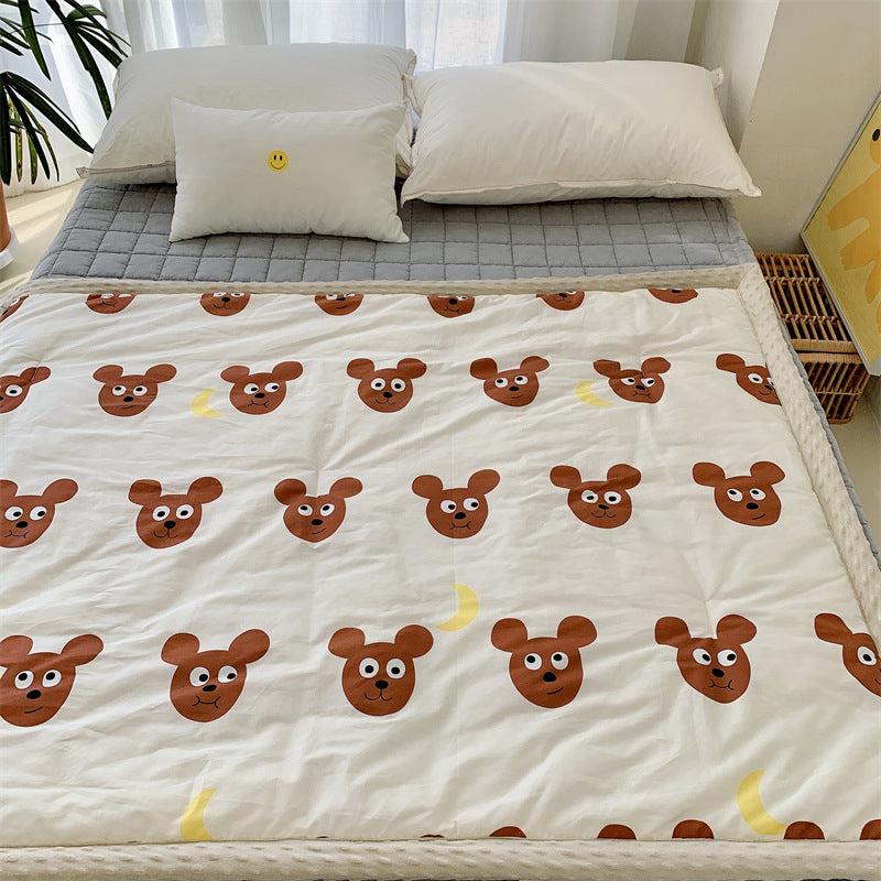 Children's quilt with colorful dinosaur print and soft minky border