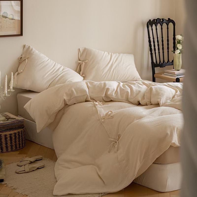 Reversible bed cover with decorative bows and light quilting