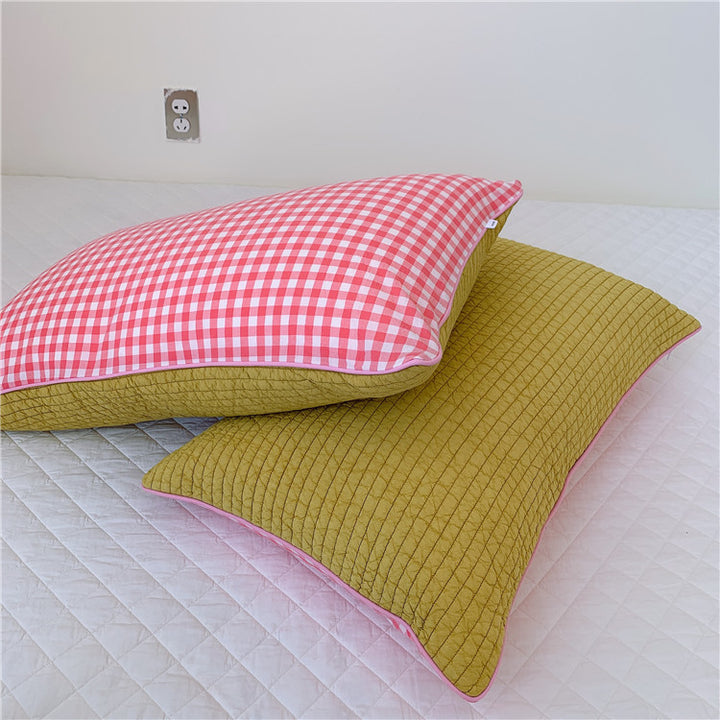 Reversible quilted pillow set with checked cotton cover and contrasting piping