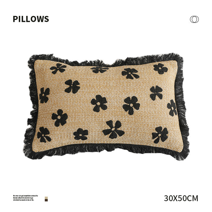 Rectangular woven decorative pillow with contrasting flower tufting and fringe trim