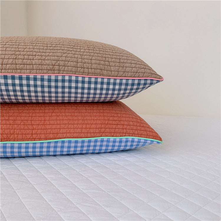 Reversible quilted pillow set with checked cotton cover and contrasting piping
