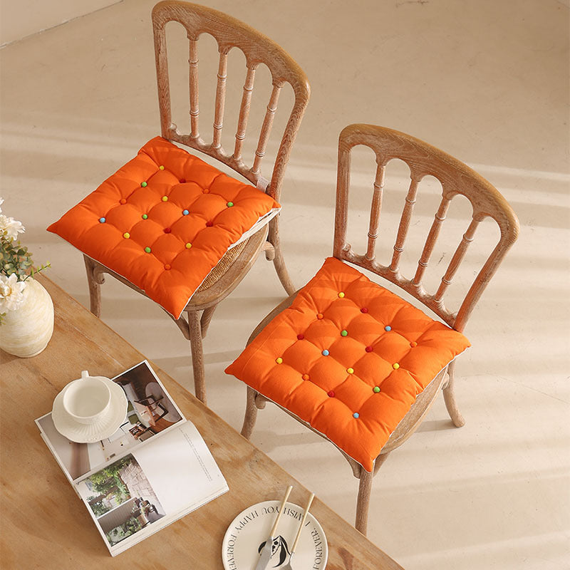 Padded quilted seat cushion with colorful button applications and non-slip underside Kalsten