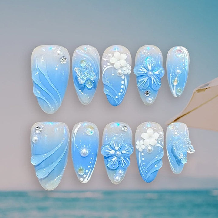 Artificial nail creation with floral designs and glitter accents Kalsten