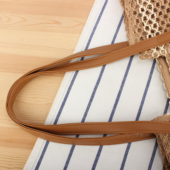 Shopping bag made of woven natural material with elegant leather handles Kalsten