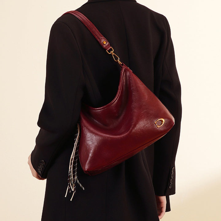 Elegant Hobo Handbag with Decorative Tassels