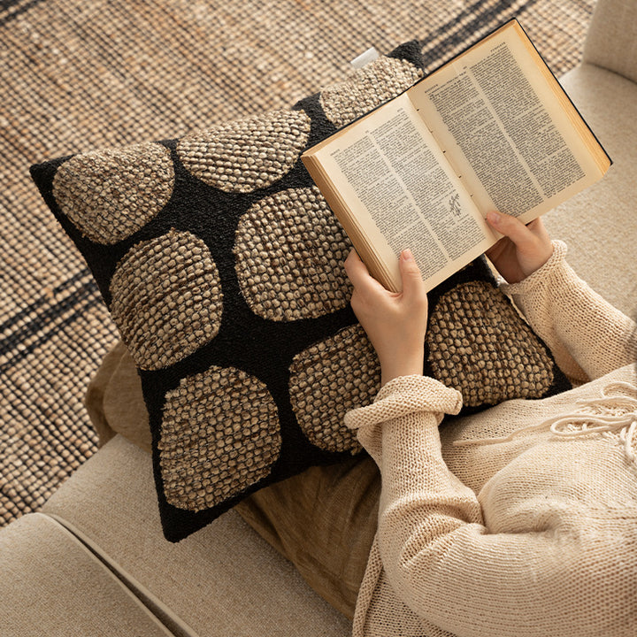 Decorative cushion cover made of textured bouclé weaving technique with raised round appliqués