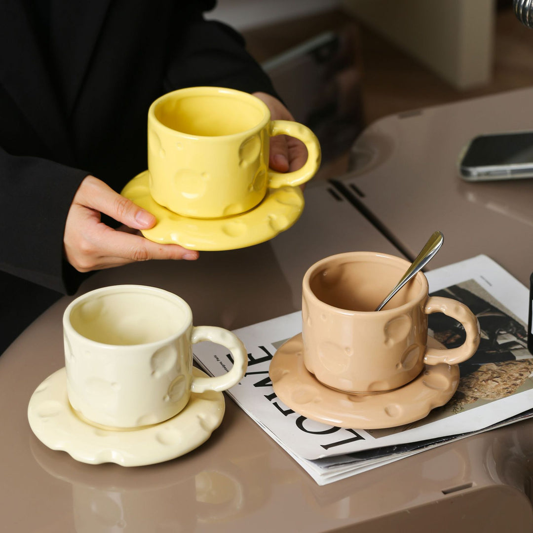 Sculptural ceramic cup set with flowing glaze and textured saucer