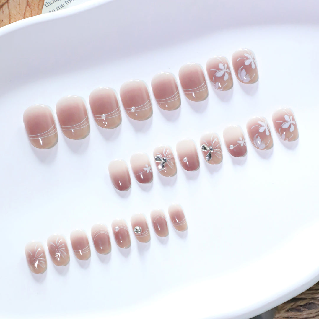 Artful nail design with floral pattern and glitter accents Kalsten